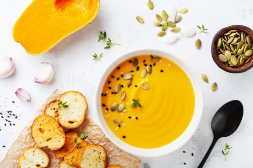 Autumn,Pumpkin,Cream,Soup,In,Bowl,Served,With,Seeds,And